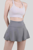 Dark gray athletic skort with a flowy skirt overlay and built-in compression shorts - Athlesi
