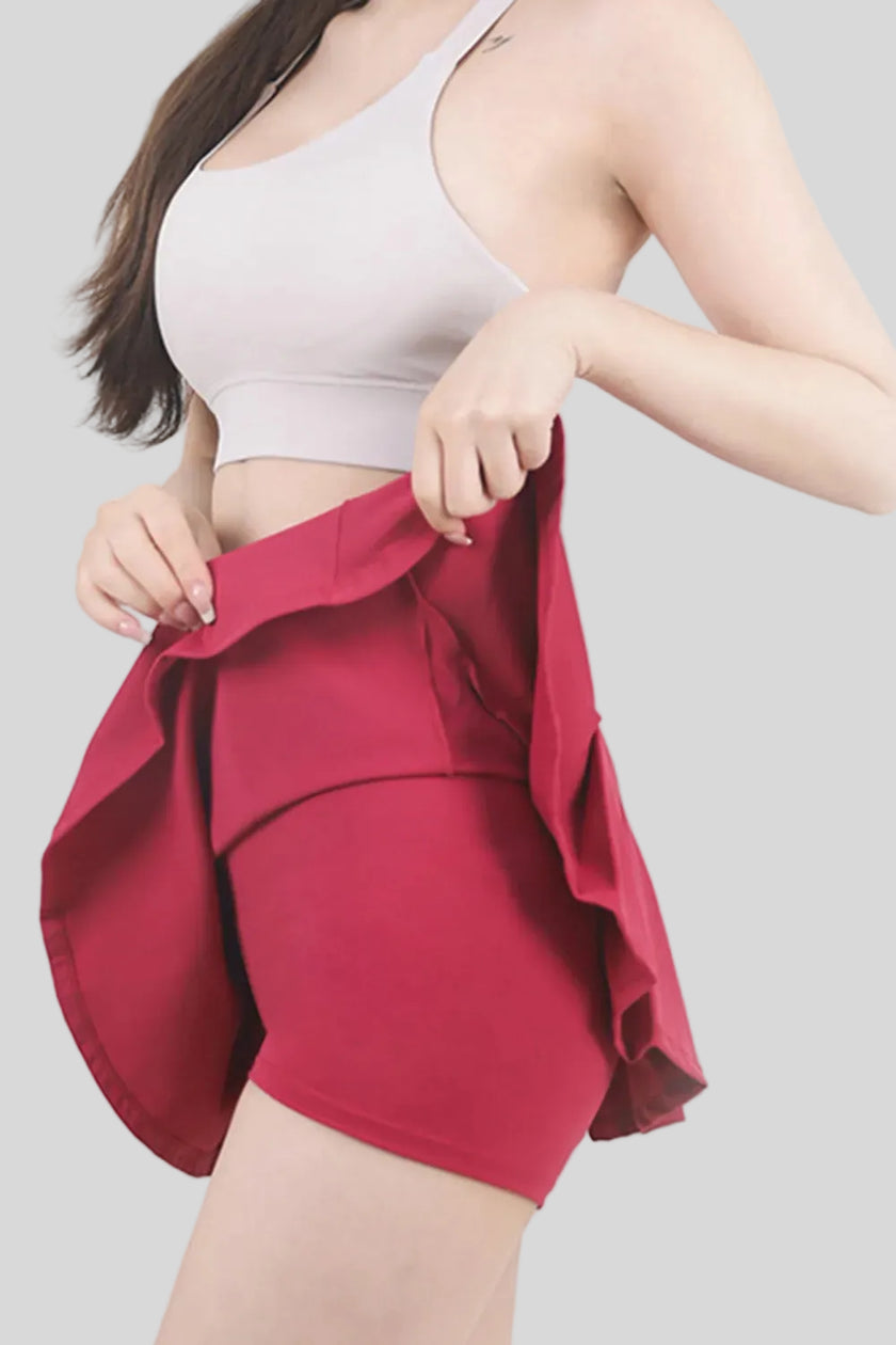 Hot pink athletic skort showing built-in compression shorts - Athlesi