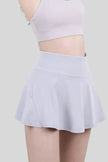 Close-up of a white, moisture-wicking tennis skirt with a wide waistband - Athlesi