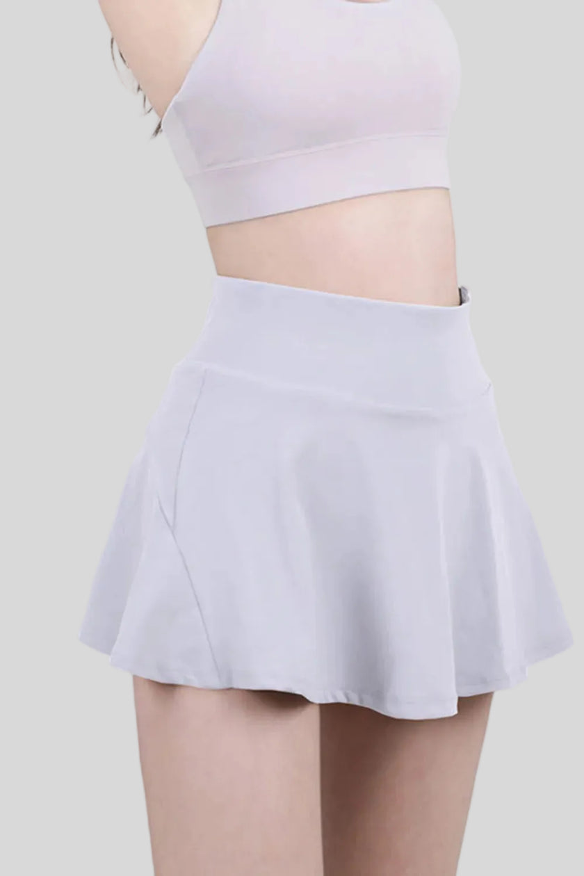 Close-up of a white, moisture-wicking tennis skirt with a wide waistband - Athlesi