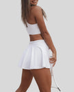 Angled back view showing cross-back straps and cutout design in white