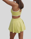 Angled back view showing cross-back straps and cutout design in yellow green
