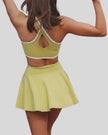 Back closeup of active dress highlighting wide straps and smooth performance fabric in yellow green