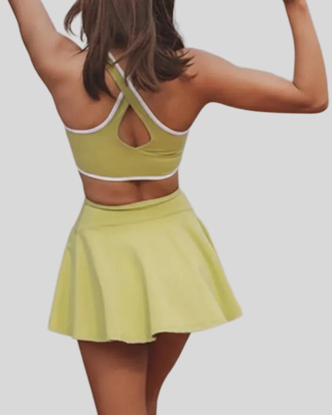 Back closeup of active dress highlighting wide straps and smooth performance fabric in yellow green