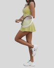 Side view of active dress with sculpted cutout detail in yellow green