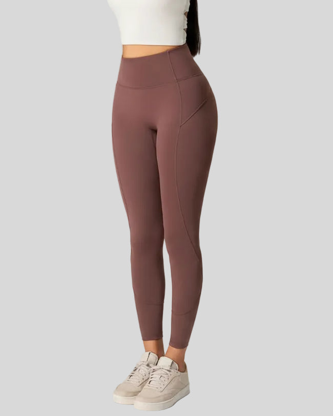 Front angle view of CurveSculpt Contour Legging in dark brown, highlighting curved leg seams