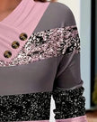 Closeup of draped neckline and decorative buttons on carnation pink colorblock top