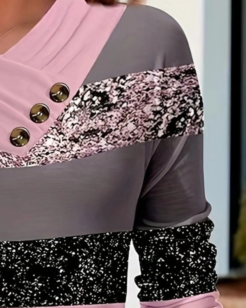 Closeup of draped neckline and decorative buttons on carnation pink colorblock top