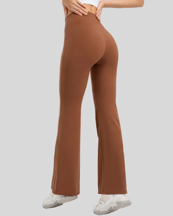 Back angle of EarthFlow Sculpt Flare Pant in caramel showing smooth fit and flowing flare