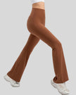 Side view of EarthFlow Sculpt Flare Pant in caramel highlighting wide waistband and flare