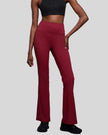 Front side view of EarthFlow Studio Flare Pant in burgundy showing high-waist fit