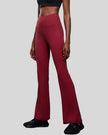 Left side view of EarthFlow Studio Flare Pant in burgundy highlighting flare leg