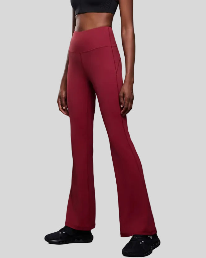 Left side view of EarthFlow Studio Flare Pant in burgundy highlighting flare leg