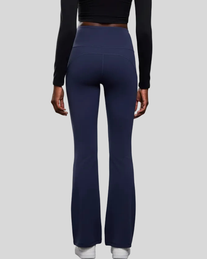 Back view of EarthFlow Studio Flare Pant in dark blue with clean, seamless waistband