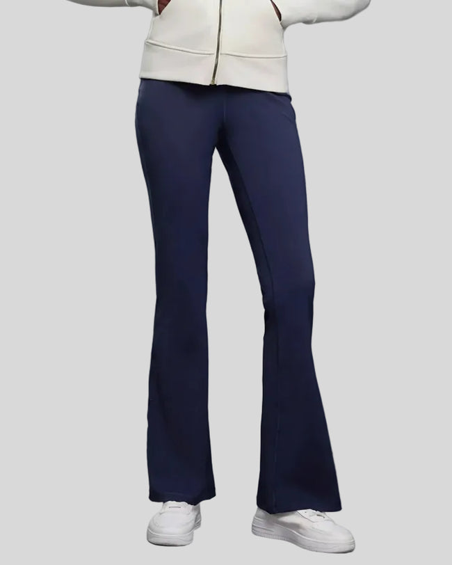 EarthFlow Studio Flare Pant in dark blue styled with an active jacket, front view