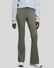 EarthFlow Studio Flare Pant in sage styled with an active jacket, front view