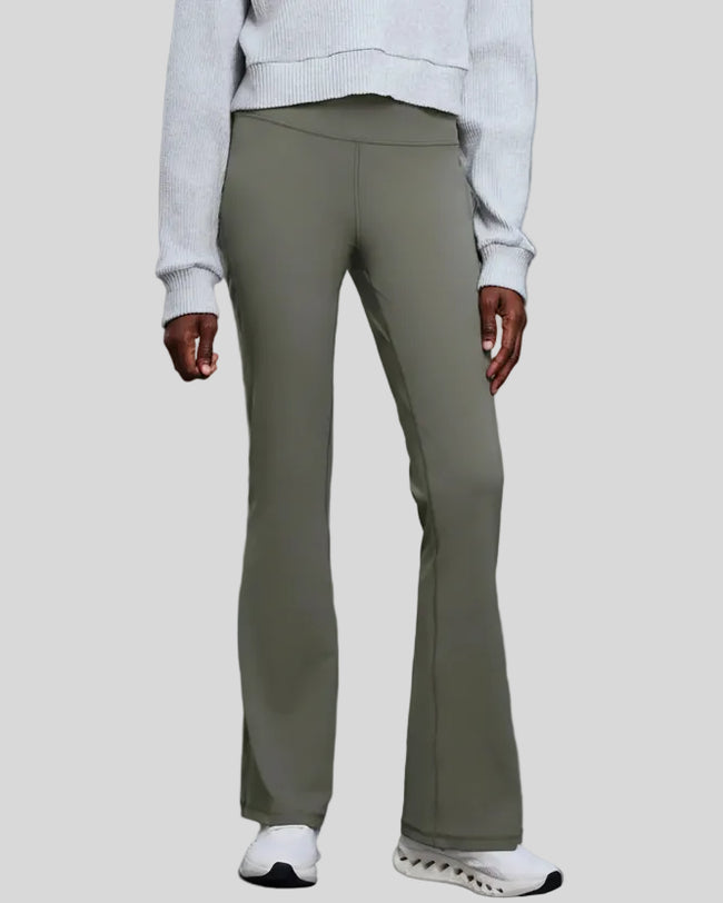 EarthFlow Studio Flare Pant in sage styled with an active jacket, front view