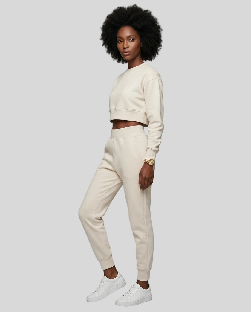 Model wearing apricot Athlesi EaseForm cropped sweatshirt and jogger set