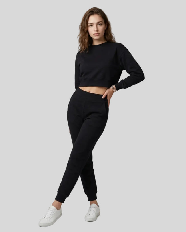Model wearing black Athlesi EaseForm cropped sweatshirt and jogger set