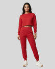 Model wearing red Athlesi EaseForm cropped sweatshirt and jogger set