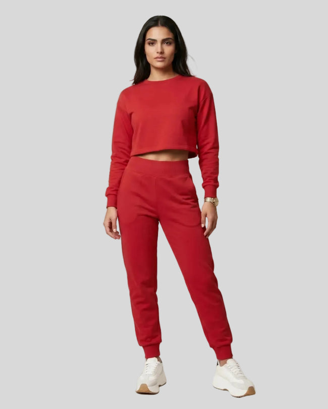 Model wearing red Athlesi EaseForm cropped sweatshirt and jogger set