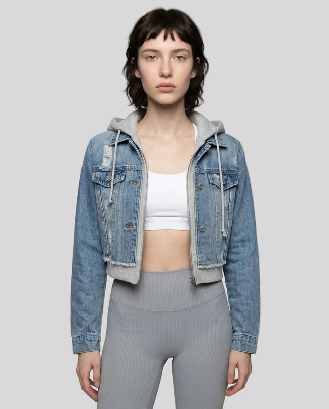 Woman wearing a dark blue and gray Athlesi EdgeForm denim hoodie jacket with gray leggings, mid body front view on model showing cropped fit and layered hoodie 