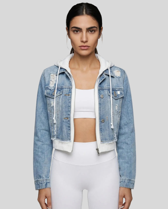 Woman wearing a dark blue and white Athlesi EdgeForm denim hoodie jacket with white leggings, mid body front view on model showing cropped fit and layered hoodie 