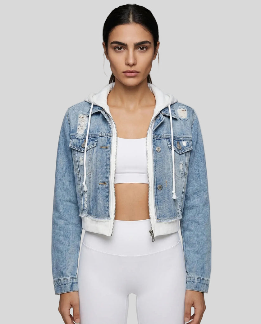 Woman wearing a dark blue and white Athlesi EdgeForm denim hoodie jacket with white leggings, mid body front view on model showing cropped fit and layered hoodie 