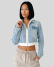 Front view of model wearing Athlesi EdgeForm light blue denim jacket and beige pants