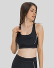 Angled front view of the EdgeForm Sports Bra in Black highlighting sculpted fit and contrast lines
