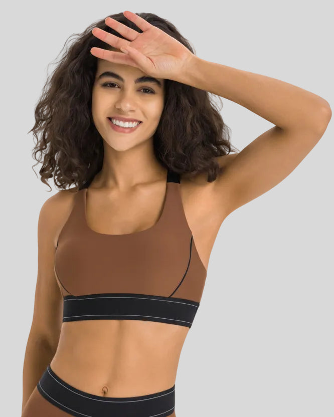 Angled front view of the EdgeForm Sports Bra in Chocolate highlighting sculpted fit and contrast lines