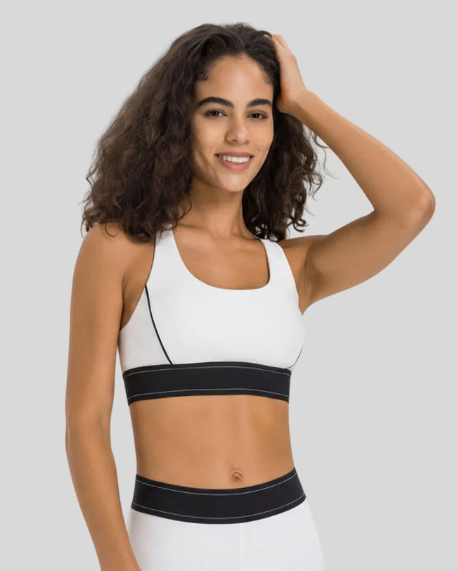 Angled front view of the EdgeForm Sports Bra in White highlighting sculpted fit and contrast lines