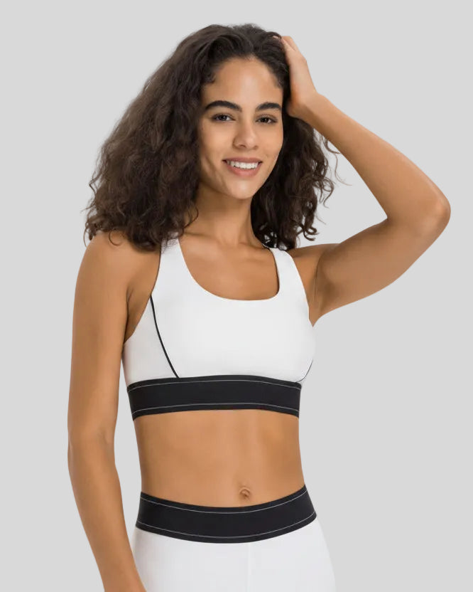 Angled front view of the EdgeForm Sports Bra in White highlighting sculpted fit and contrast lines