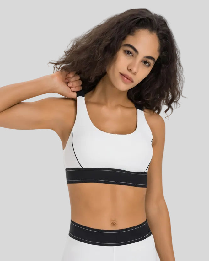 EdgeForm Sports Bra in White with rounded neckline and contrast detailing shown from the front