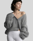 Woman wearing dark gray EmberSoft fuzzy button cardigan closed in a relaxed elevated streetwear look