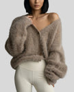 Woman wearing khaki EmberSoft fuzzy button cardigan closed in a relaxed elevated streetwear look