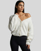 Woman wearing white EmberSoft fuzzy button cardigan closed in a relaxed elevated streetwear look