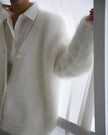 Person wearing a white shirt and white Embersoft Cardigan against a white background