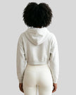 Model wearing Everyday Cropped Hoodie in Oat Gray back view