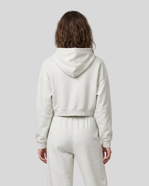 Model wearing Everyday Cropped Hoodie in Oat Gray back view