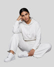 Model wearing Everyday Cropped Hoodie in White sitting down view