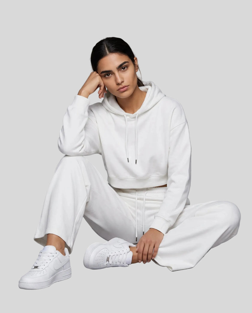 Model wearing Everyday Cropped Hoodie in White sitting down view