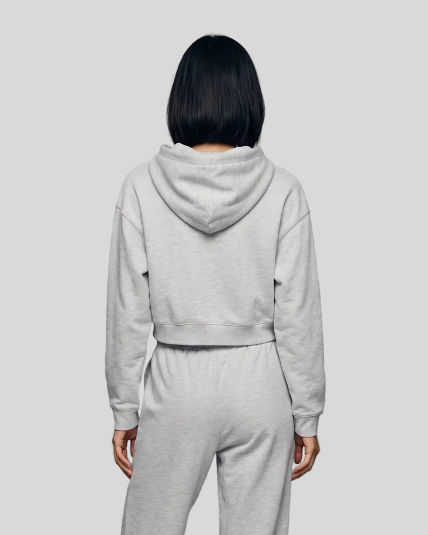 Back view of a model wearing the Everyday Cropped Zip-Up Hoodie in Flower Gray
