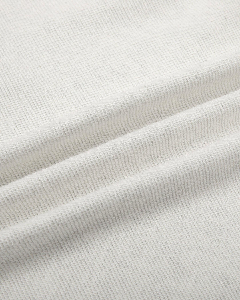 Close-up of the soft cotton-blend fleece fabric on the Everyday Cropped Zip-Up Hoodie in Oat Gray