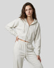 Model wearing the Everyday Cropped Zip-Up Hoodie in Oat Gray viewed from the front