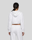 Back view of a model wearing the Everyday Cropped Zip-Up Hoodie in White
