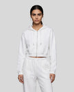 Model wearing the Everyday Cropped Zip-Up Hoodie in White viewed from the front