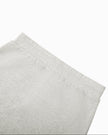 Close-up of the back elastic waistband on the Everyday Drawstring Skirt in Oat Gray