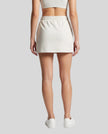 Back view of a model wearing the Everyday Drawstring Skirt in Oat Gray