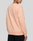Upper body back angle view of woman wearing Everyday Oversized Sweatshirt in Pink